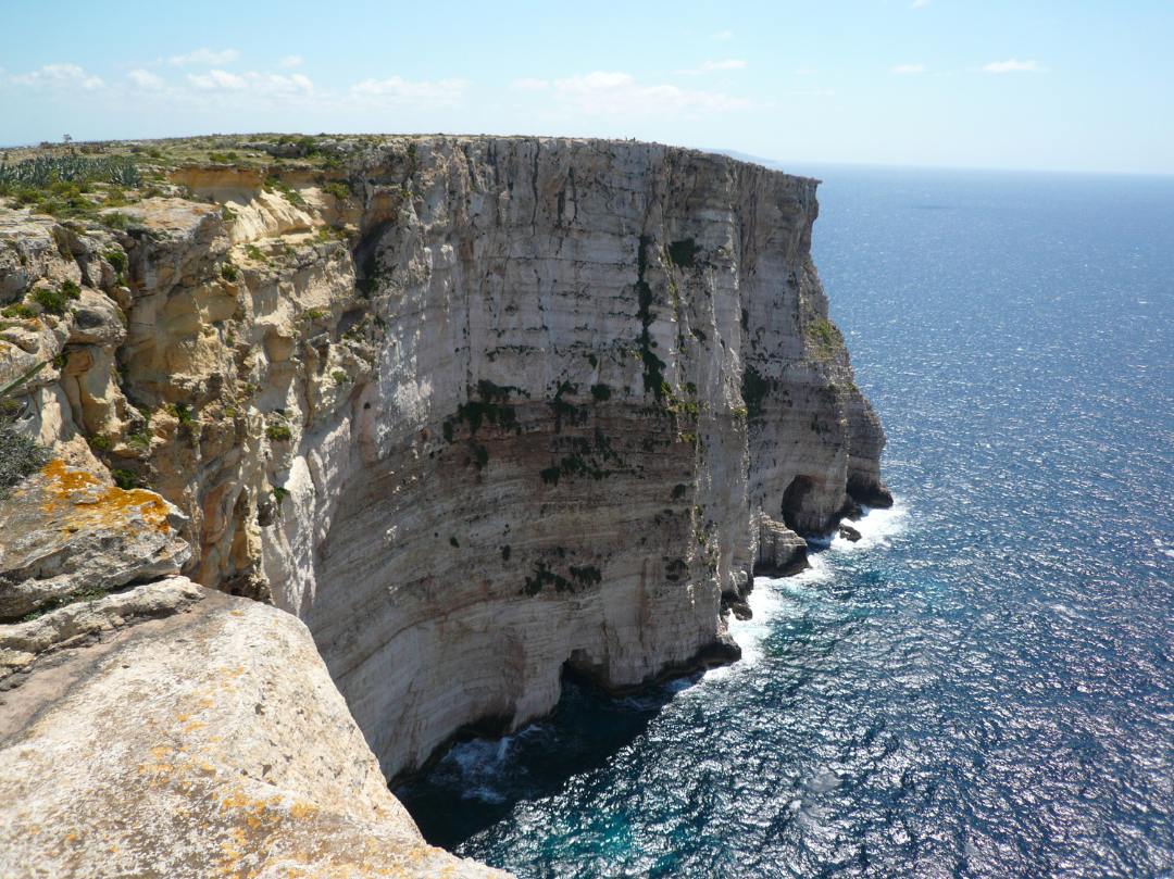 Dramatic ta cenc cliffs, surrounded by calm seas